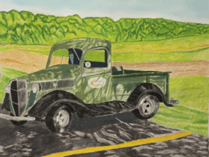 old time green truck in parking lot with field in background